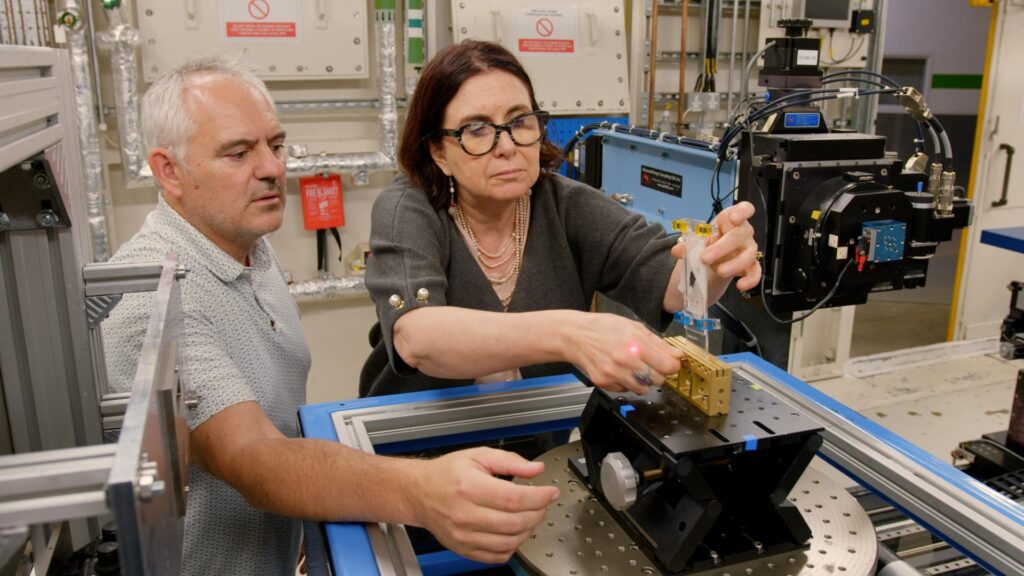 a man and a woman analyze herculaneum scrolls