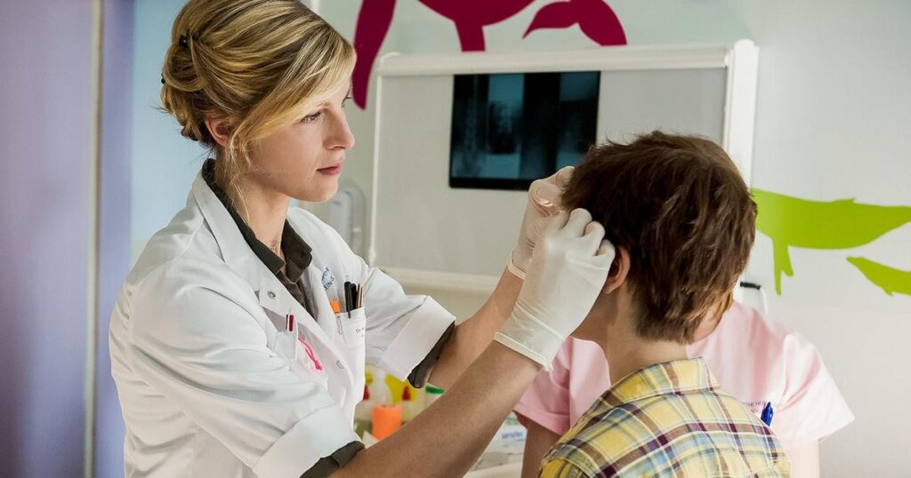 a nurse performs a check up on a child