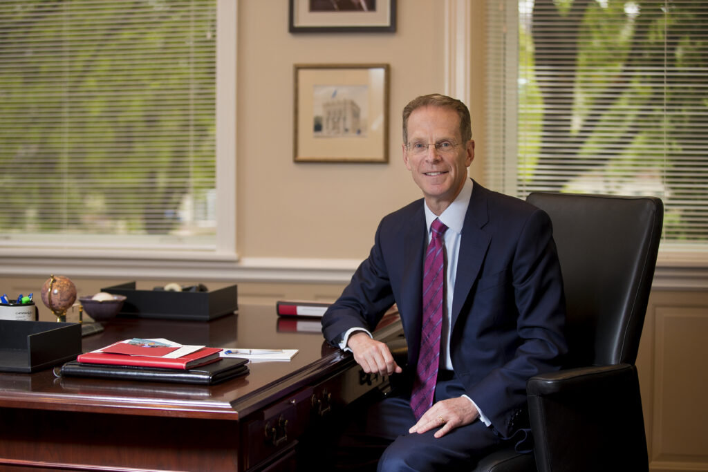 Geoffrey S. Mearns sitting at his desk
