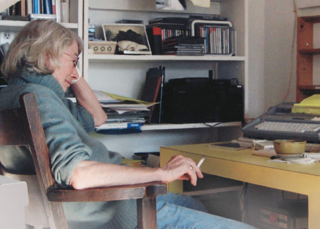 Mary seated at typewriter - MARY OLIVER_ SAVED BY THE BEAUTY OF THE WORLD