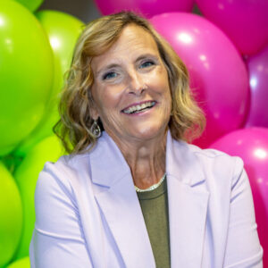 Headshot of Michelle Kinsey in front of green and pink balloons