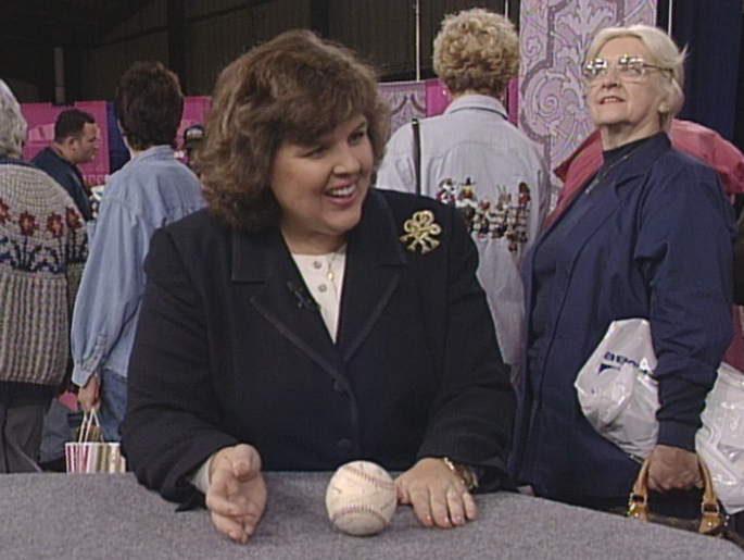Kathleen Guzman appraises a 1950 Women’s Pro League baseball in Chicago, IL.